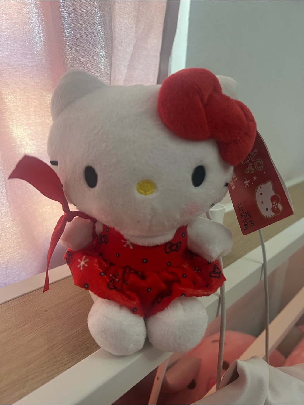Hello Kitty Christmas-themed plush toy wearing a festive red dress